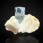 Aquamarine with intergrown schorl on feldspar