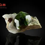 Andradite var demantoid garnet on calcite specimen